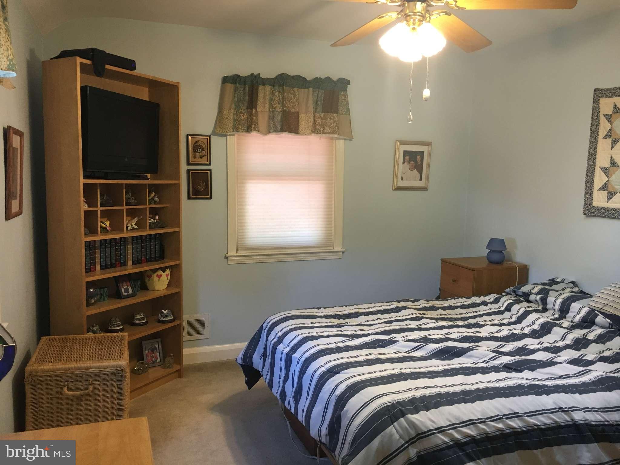 6010 Falkirk Road Baltimore, MD 21239 - Photo 8 of 30 a bedroom with a bed and a television