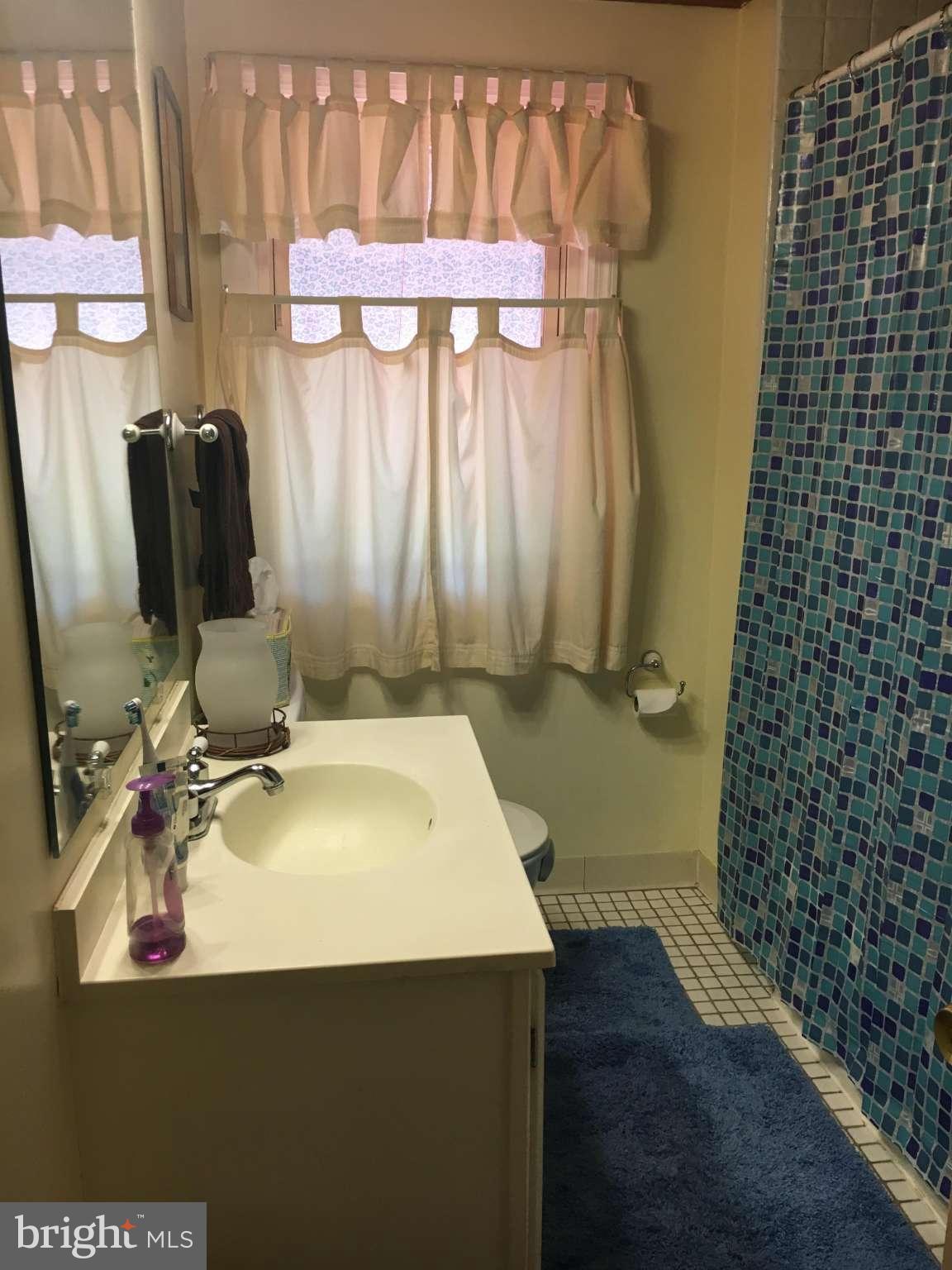 6010 Falkirk Road Baltimore, MD 21239 - Photo 9 of 30 a bathroom with a sink and a mirror