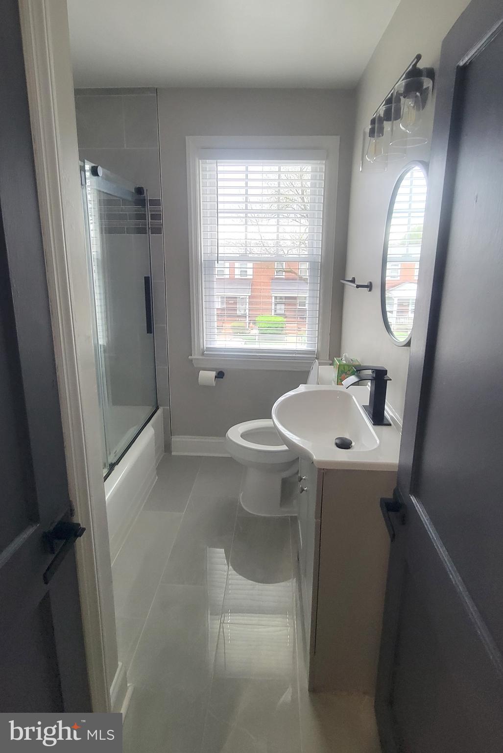 202 Edgewood Street Baltimore, MD 21229 - Photo 19 of 29 a bathroom with a sink toilet and a mirror