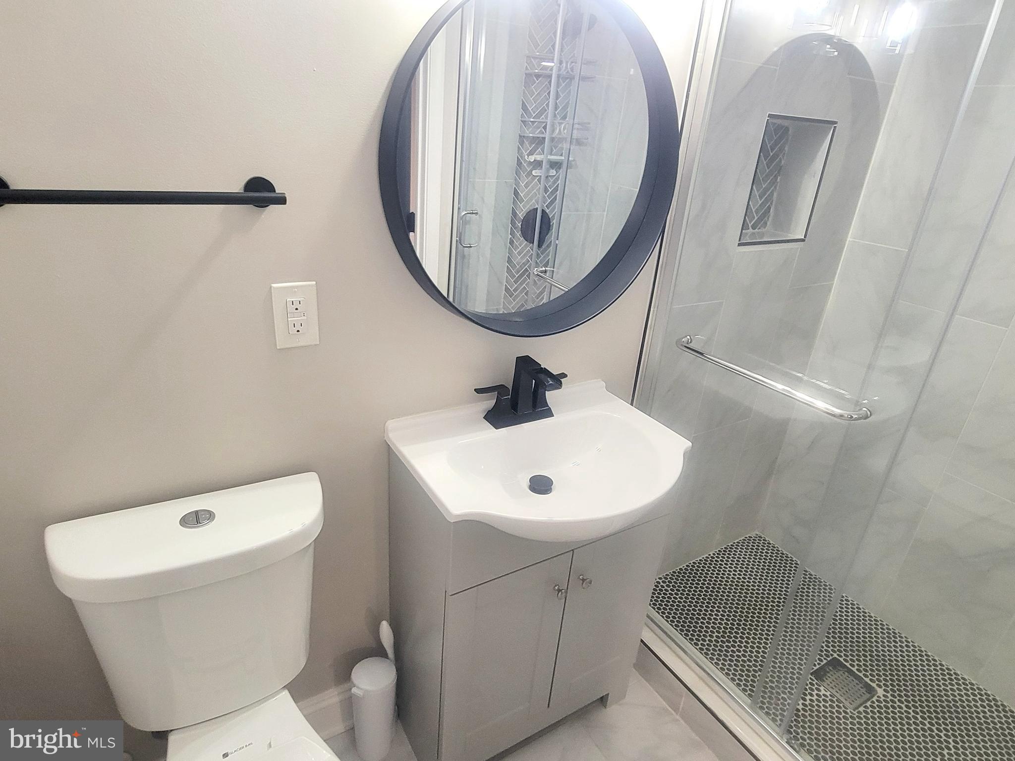 202 Edgewood Street Baltimore, MD 21229 - Photo 26 of 29 a bathroom with a sink toilet and a mirror