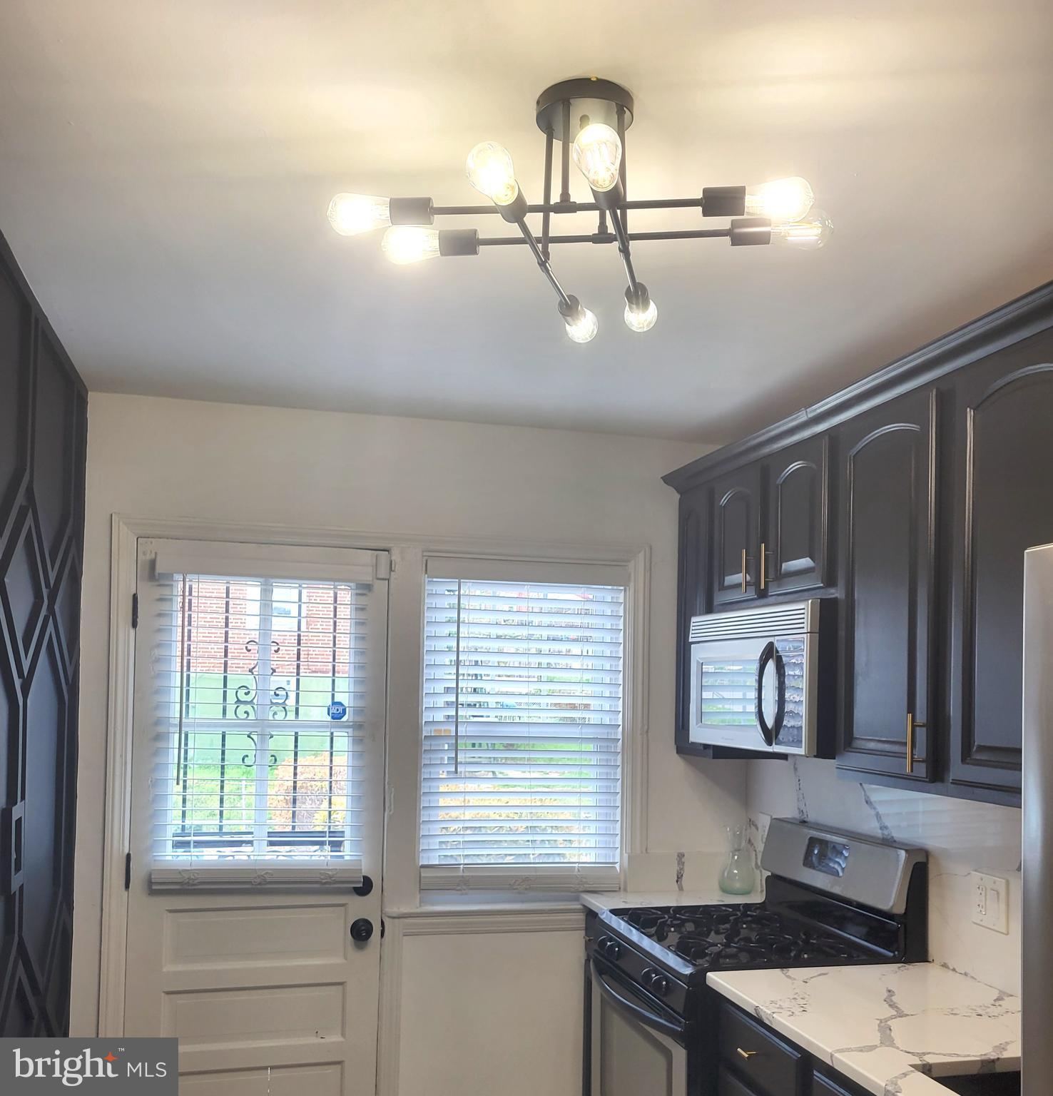 202 Edgewood Street Baltimore, MD 21229 - Photo 9 of 29 a kitchen with a window a sink and cabinets