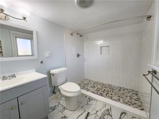 a bathroom with a sink toilet and shower