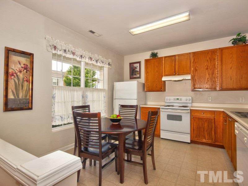8523 Bright Loop Raleigh, NC 27613 - Photo 2 of 23 a view of a dining room with furniture and a kitchen