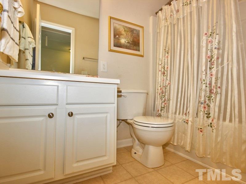 8523 Bright Loop Raleigh, NC 27613 - Photo 17 of 23 a bathroom with a toilet and a shower