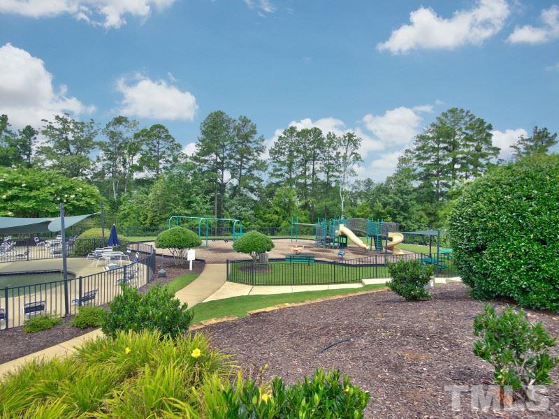 8523 Bright Loop Raleigh, NC 27613 - Photo 23 of 23 a view of yard with swimming pool and green space