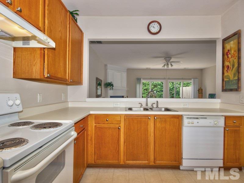 8523 Bright Loop Raleigh, NC 27613 - Photo 4 of 23 a kitchen with a sink and a stove top oven