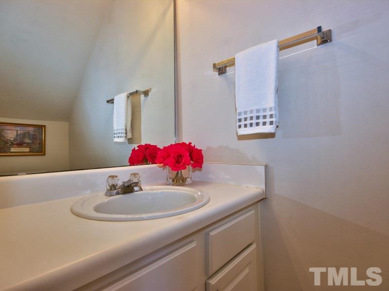 8523 Bright Loop Raleigh, NC 27613 - Photo 7 of 23 a bathroom with a sink and a mirror
