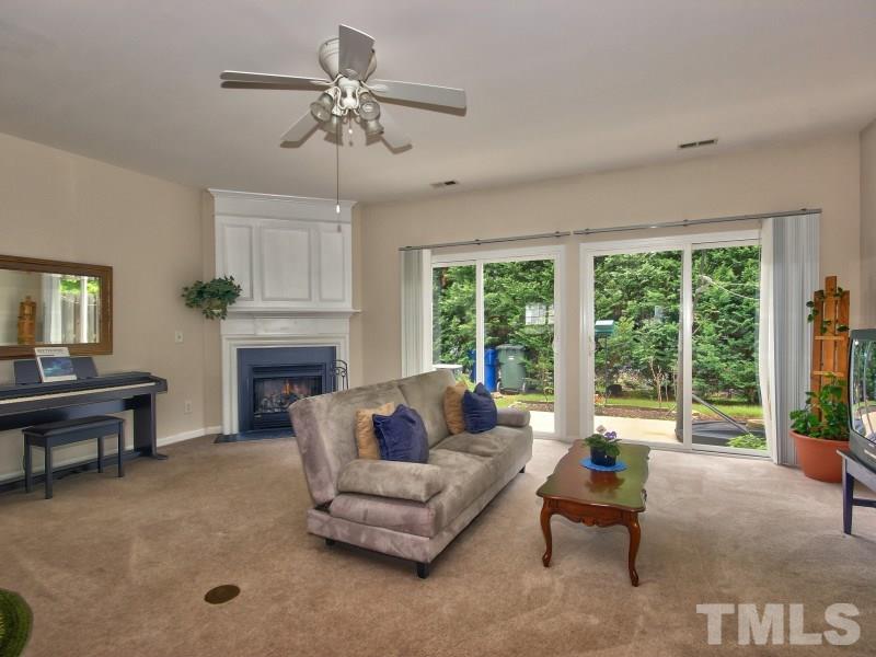 8523 Bright Loop Raleigh, NC 27613 - Photo 8 of 23 a living room with furniture and a fireplace