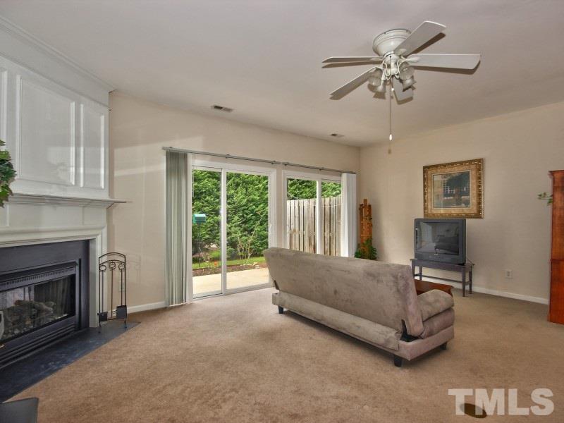 8523 Bright Loop Raleigh, NC 27613 - Photo 9 of 23 a living room with furniture and a fireplace