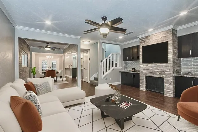 a living room with furniture a fireplace and a flat screen tv