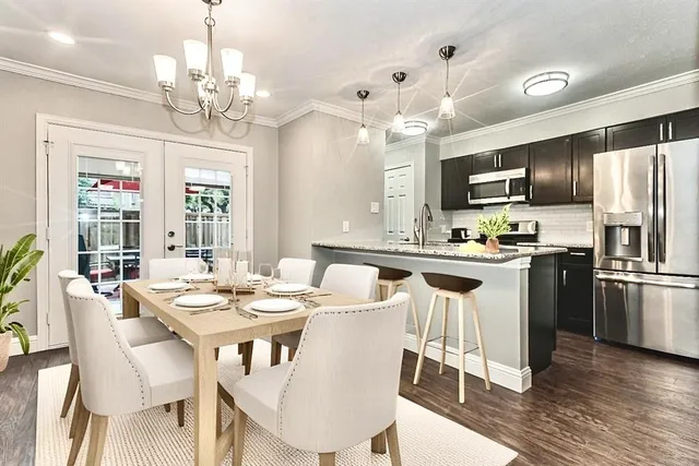 a kitchen with kitchen island a dining table and appliances