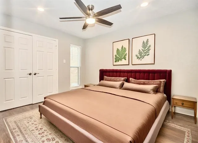 a bedroom with a large bed and a chandelier