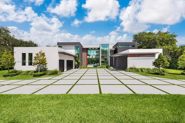 a front view of a house with a garden