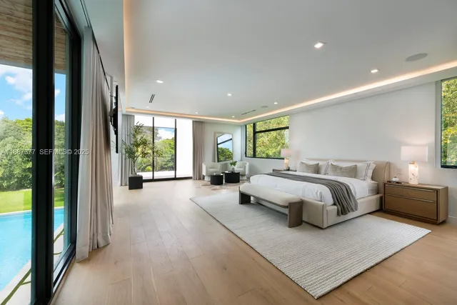 a view of an empty room with wooden floor and closet