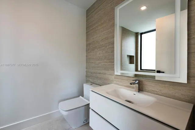 an aerial view of residential house with outdoor space and trees all around