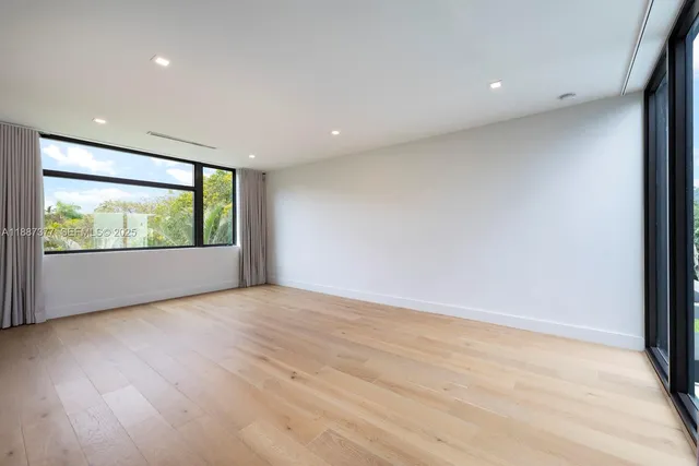 an aerial view of residential houses with city view