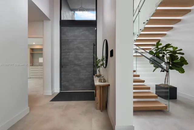 a living room with furniture and large windows