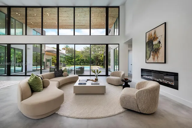 a view of a livingroom with furniture and floor to ceiling window