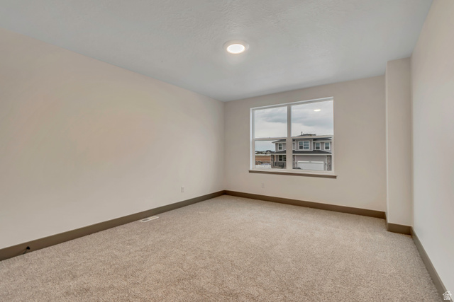 3317 South 1000 West, Unit 6010 Logan, UT 84321 - Photo 31 of 34 Spare room featuring light colored carpet and baseboards