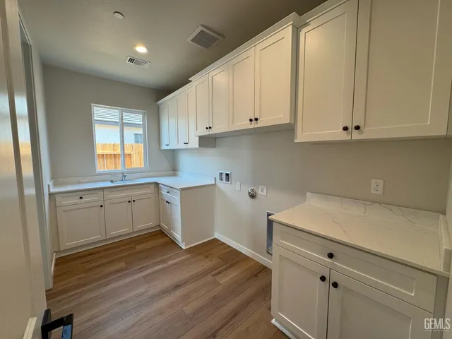a kitchen with white cabinets and white appliances