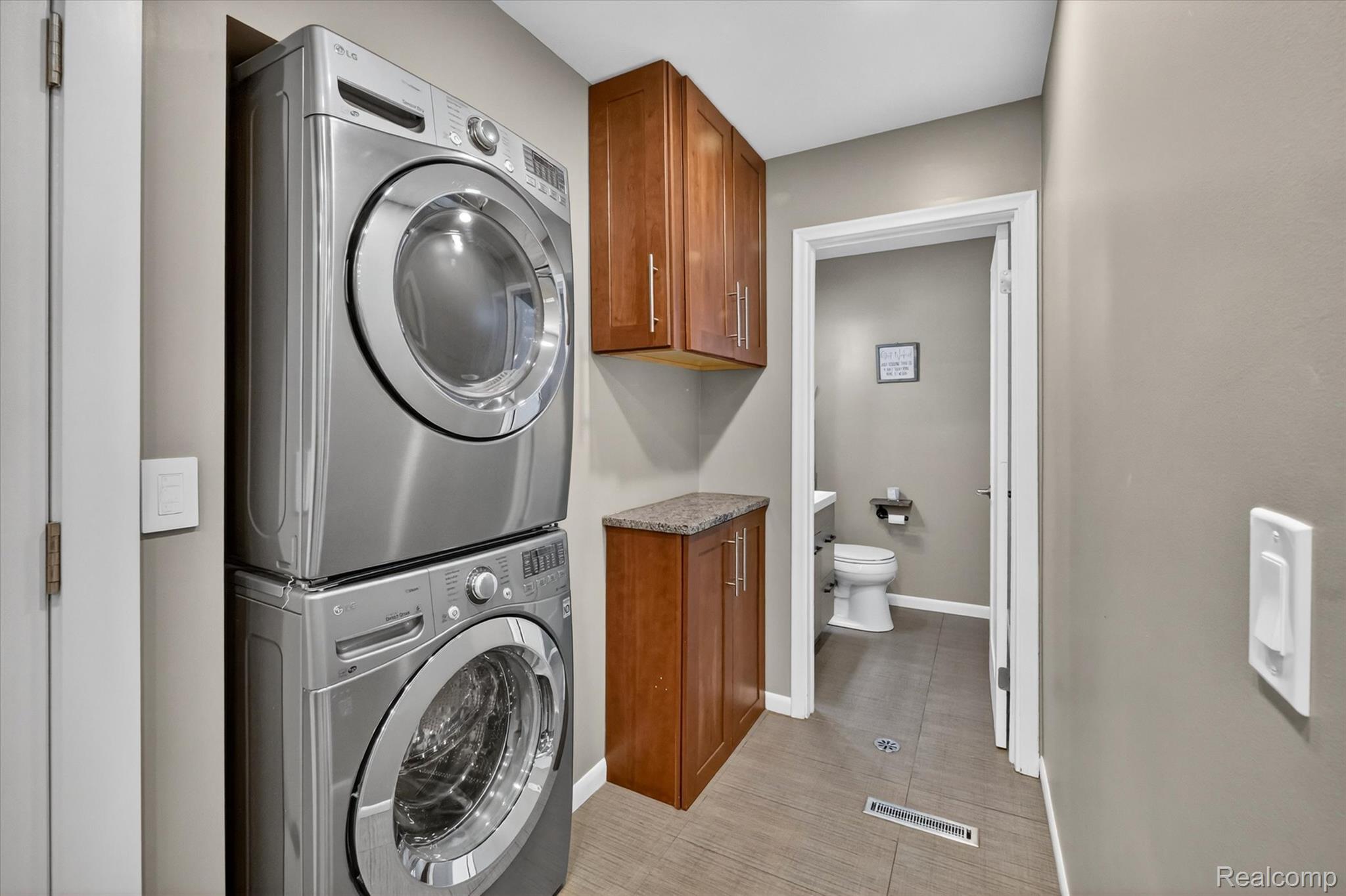 2264 Crane Road Fenton, MI 48430 - Photo 41 of 55 Laundry area with stacked washer / drying machine and cabinet space