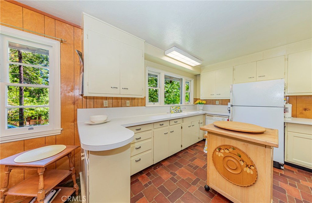 1173 Railroad Avenue Fish Camp, CA 93623 - Photo 11 of 75 a kitchen with sink a refrigerator and washer