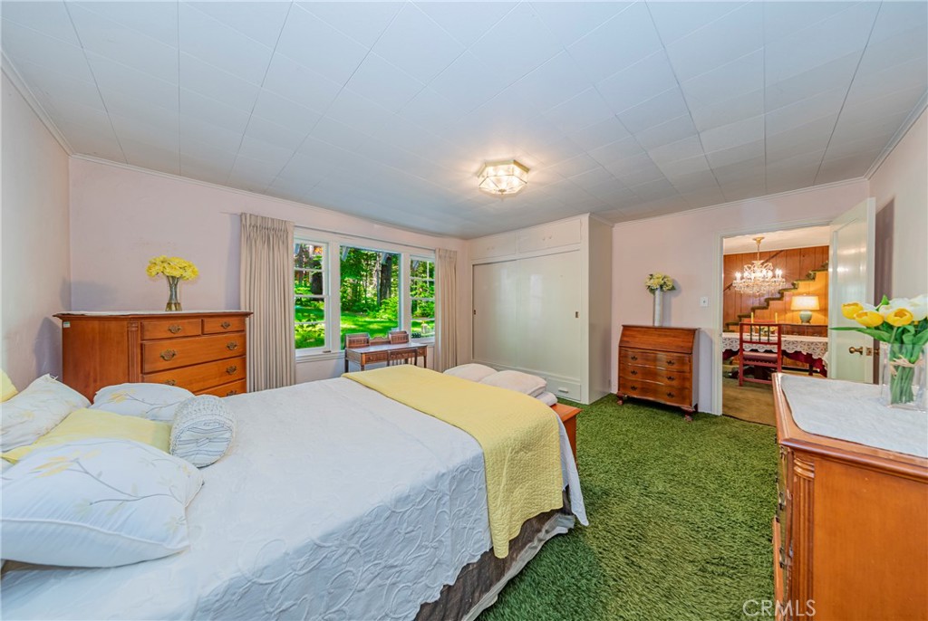 1173 Railroad Avenue Fish Camp, CA 93623 - Photo 23 of 75 a bedroom with a bed and large windows