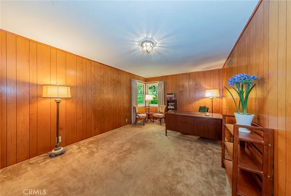 a bathroom with a granite countertop toilet sink and mirror
