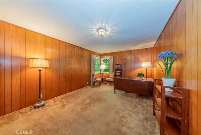 a bathroom with a granite countertop toilet sink and mirror