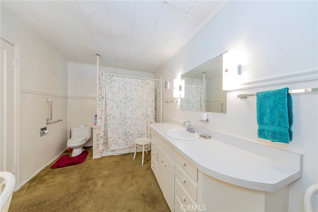 1173 Railroad Avenue Fish Camp, CA 93623 - Photo 28 of 75 a bathroom with a double vanity sink mirror and shower
