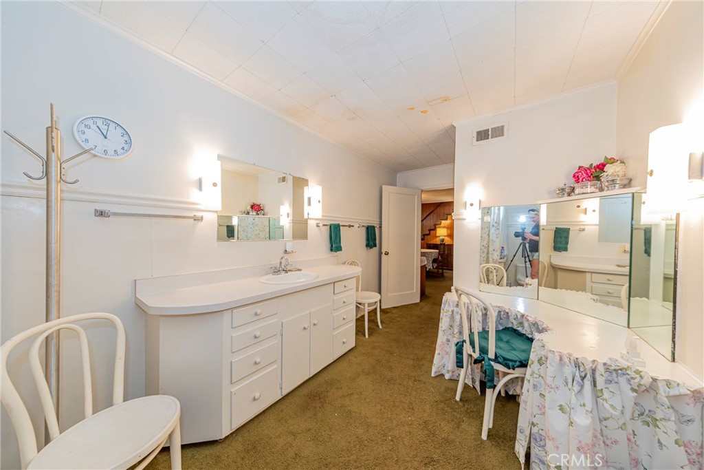 1173 Railroad Avenue Fish Camp, CA 93623 - Photo 29 of 75 a spacious bathroom with a granite countertop sink and a mirror