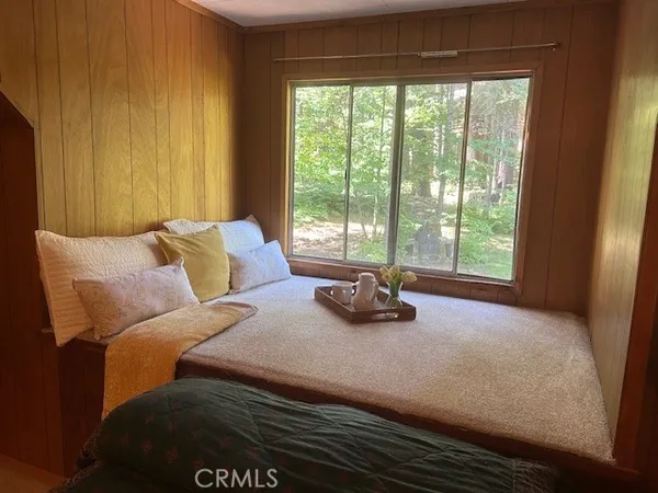 a view of a house with a big yard and large trees
