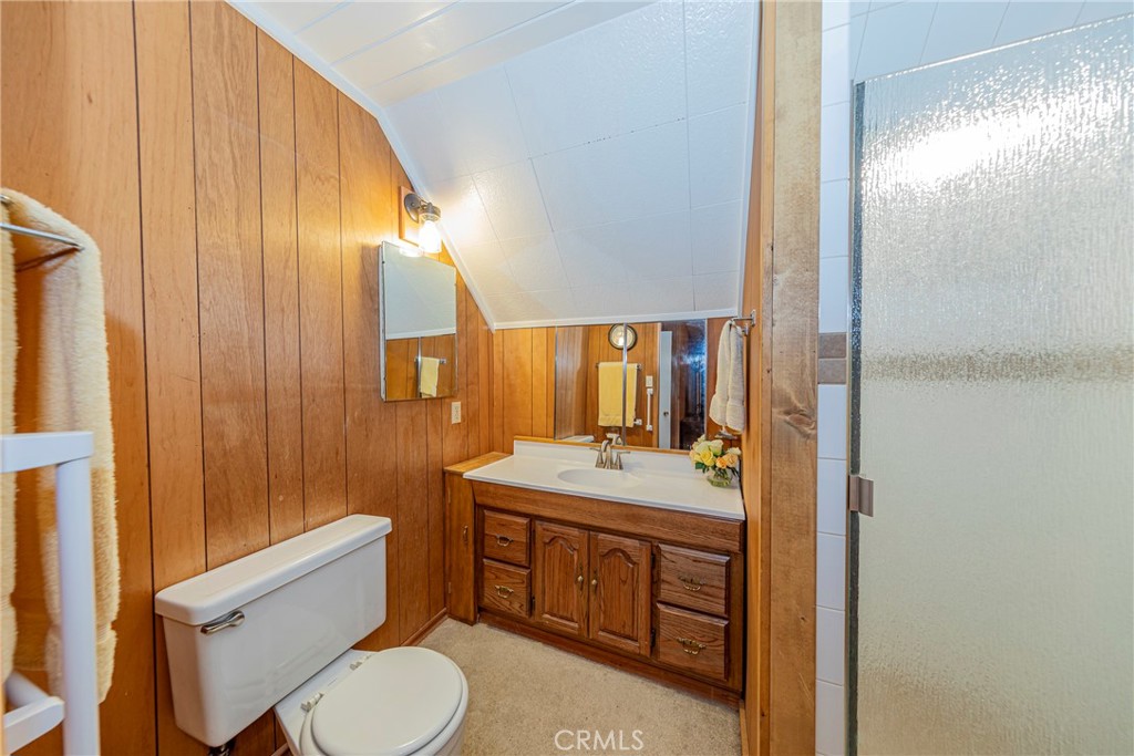 1173 Railroad Avenue Fish Camp, CA 93623 - Photo 37 of 75 a bathroom with a granite countertop toilet sink and mirror