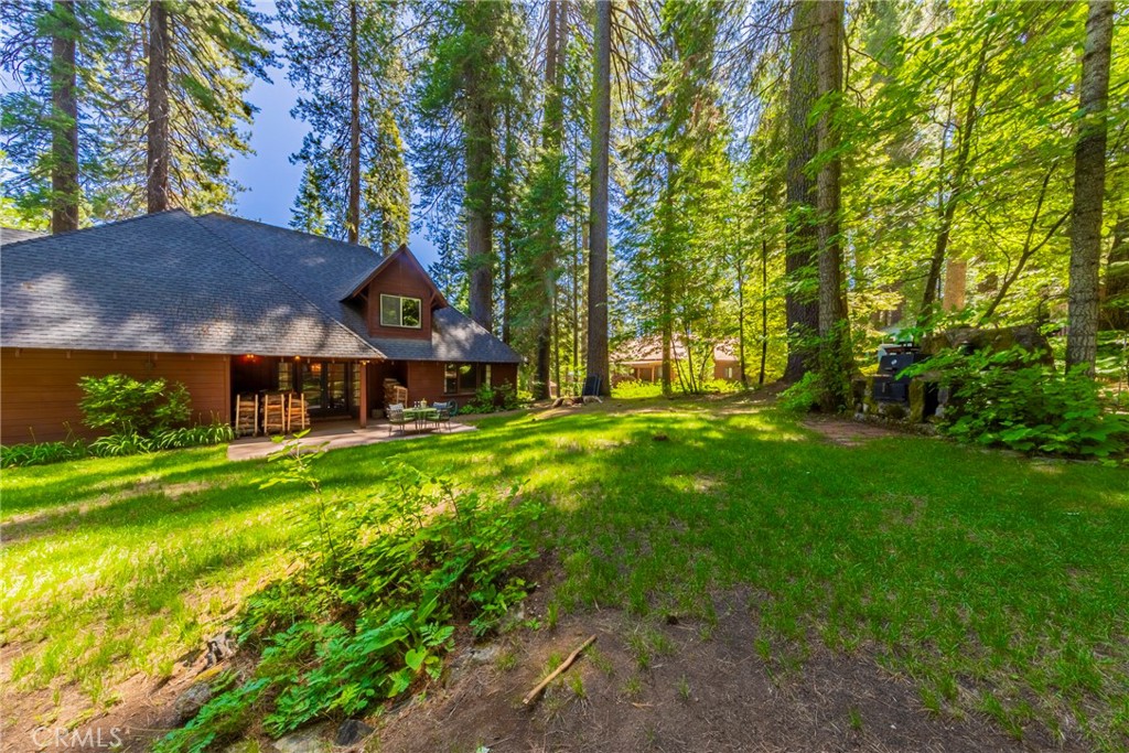 1173 Railroad Avenue Fish Camp, CA 93623 - Photo 49 of 75 a view of a house with a big yard and large trees