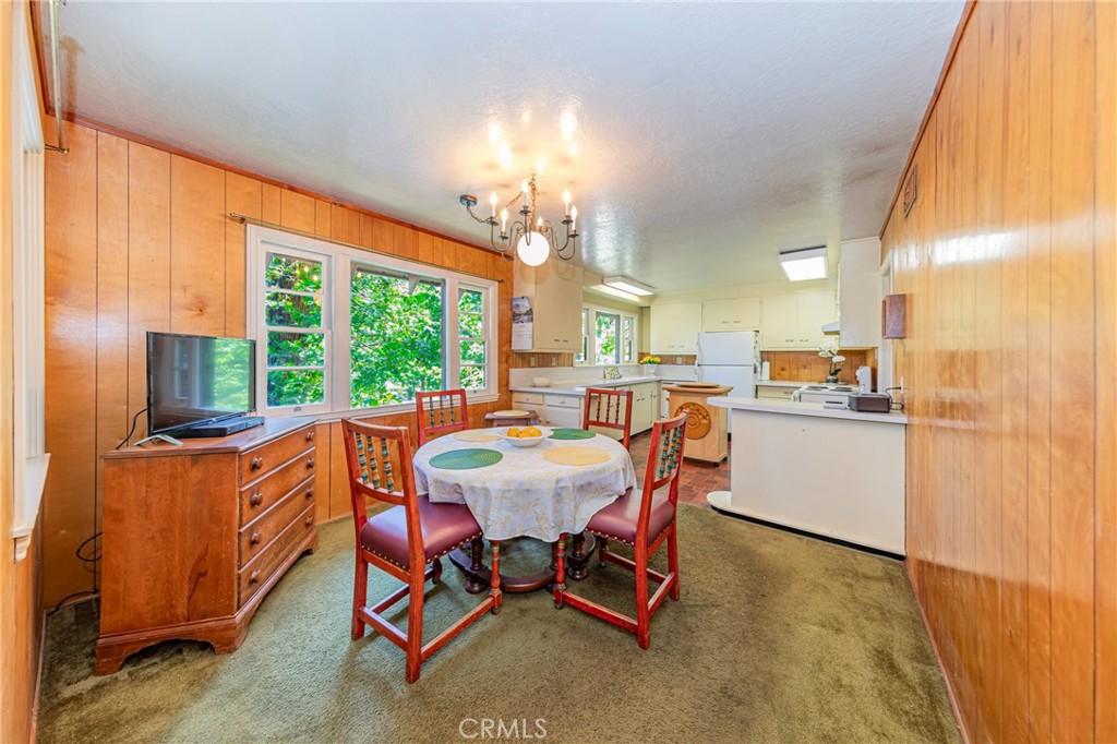 1173 Railroad Avenue Fish Camp, CA 93623 - Photo 8 of 75 a view of a dining room with furniture a chandelier and wooden floor
