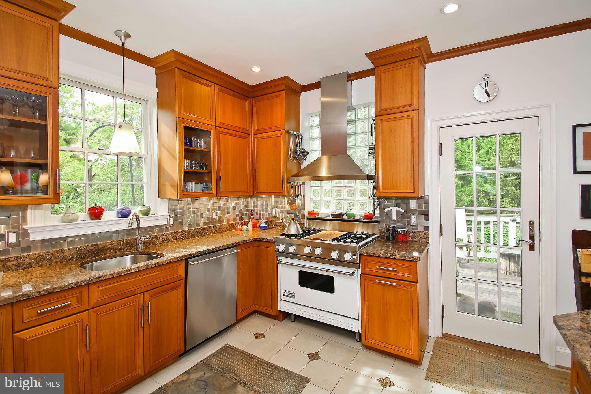 1421 Locust Road Northwest Washington, DC 20012 - Photo 13 of 30 a kitchen with stainless steel appliances a sink stove and cabinets