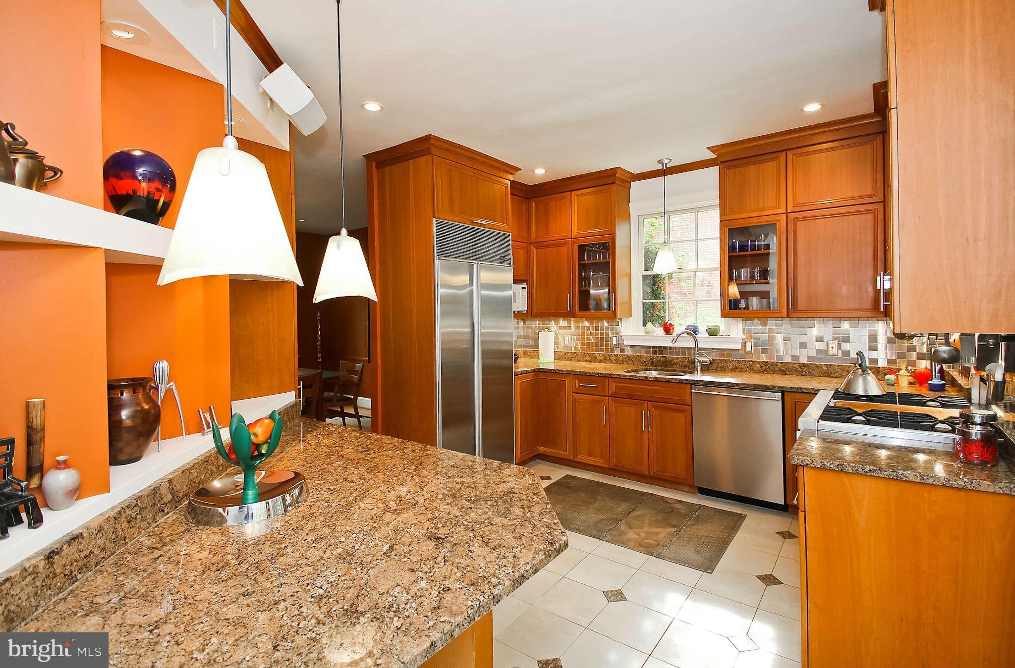 1421 Locust Road Northwest Washington, DC 20012 - Photo 14 of 30 a kitchen with stainless steel appliances kitchen island granite countertop a sink and cabinets