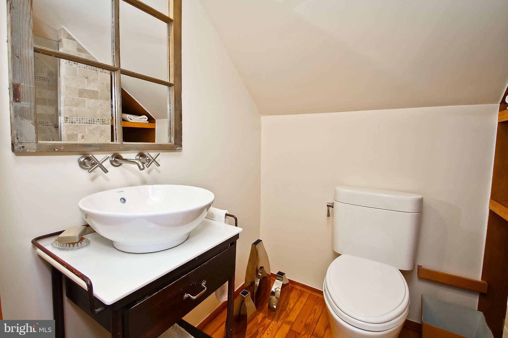 1421 Locust Road Northwest Washington, DC 20012 - Photo 15 of 30 a bathroom with a toilet a sink and a mirror
