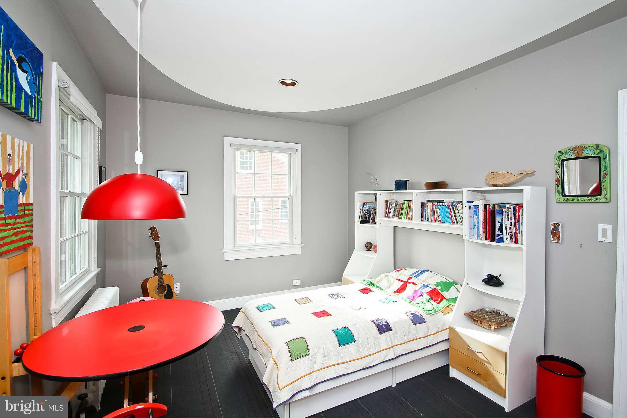 1421 Locust Road Northwest Washington, DC 20012 - Photo 22 of 30 a bedroom with a bed a chandelier and a window