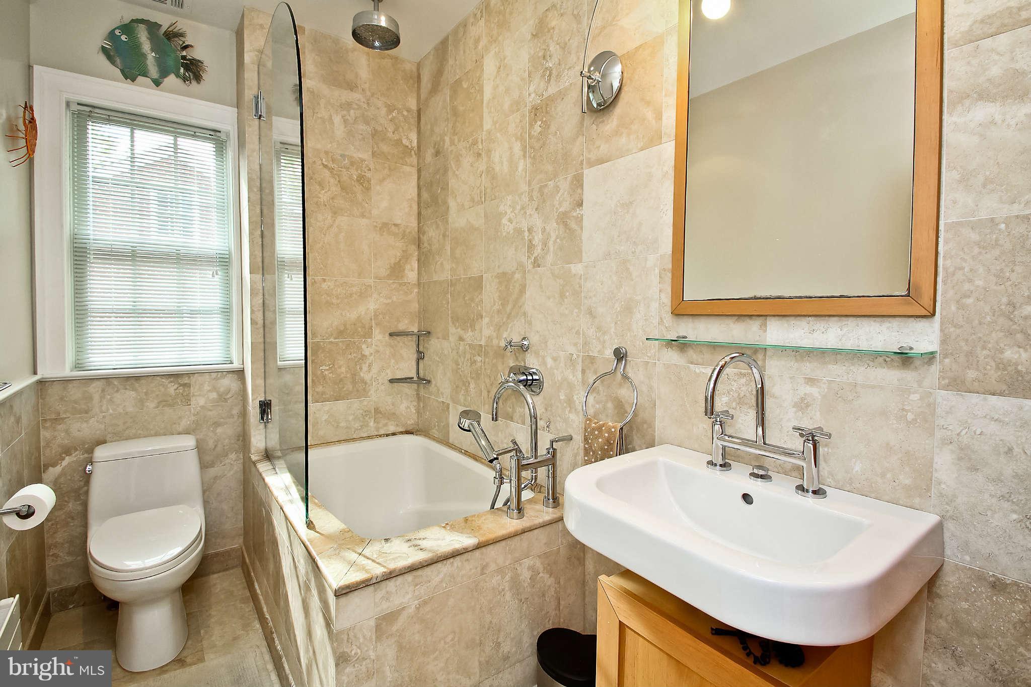 1421 Locust Road Northwest Washington, DC 20012 - Photo 24 of 30 a bathroom with a sink a toilet and shower