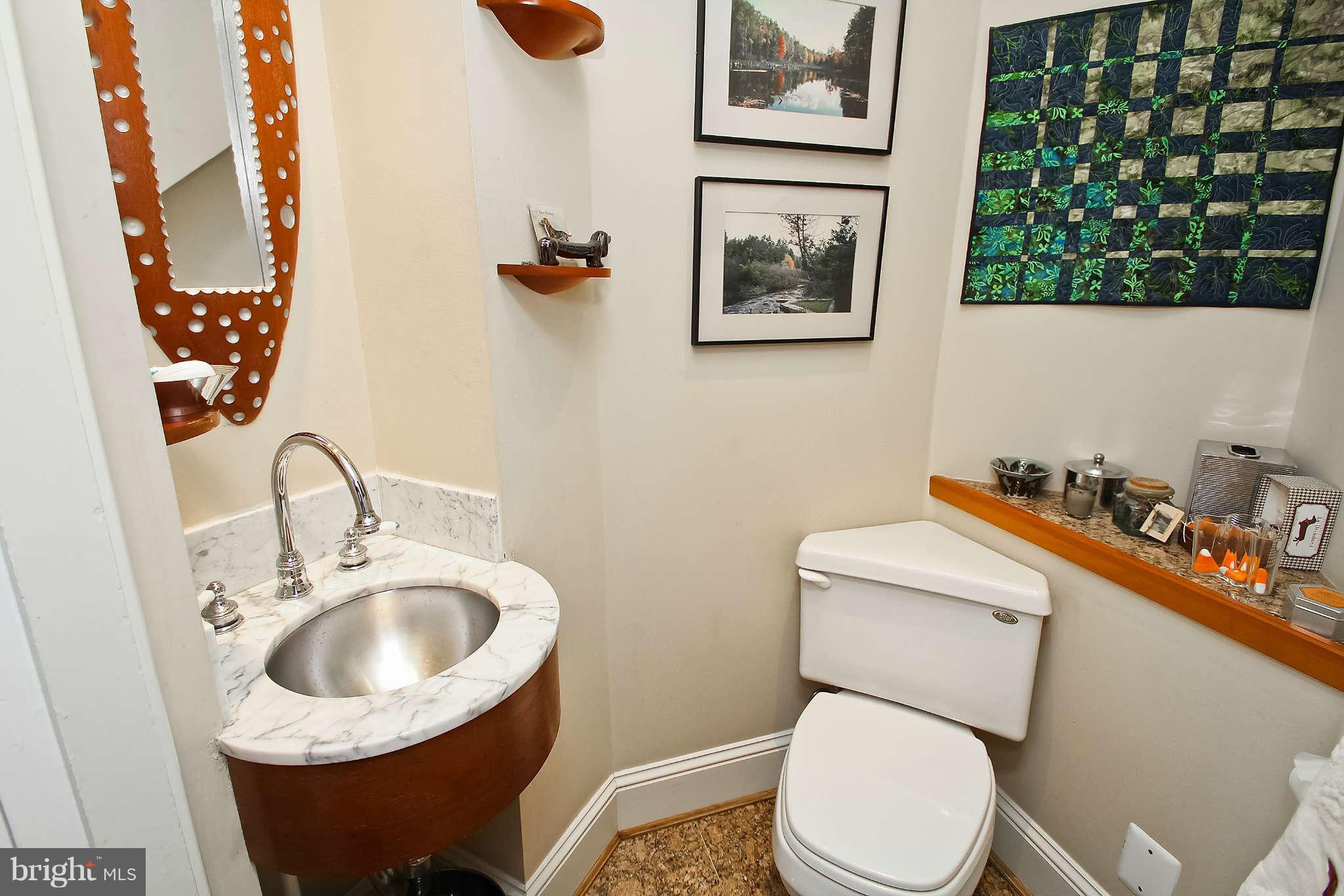 1421 Locust Road Northwest Washington, DC 20012 - Photo 27 of 30 a bathroom with a toilet sink and mirror