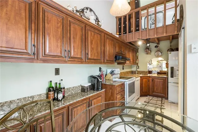 a kitchen with stainless steel appliances granite countertop a sink and cabinets