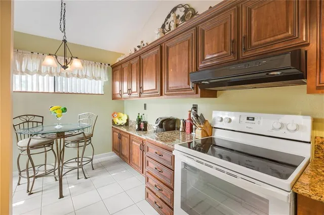 a en suite bathroom with a granite countertop double vanity sink a mirror and a shower
