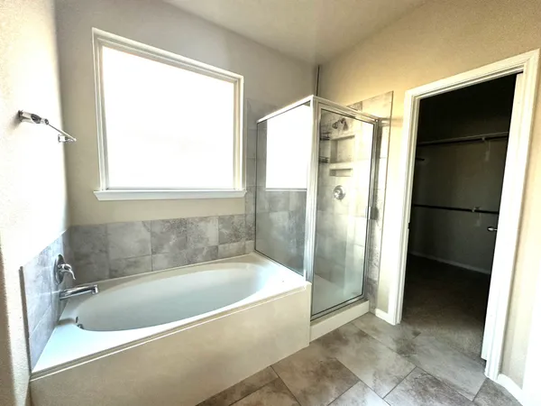 a bathroom with a bathtub and a shower