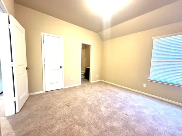 an empty room with windows and entrance