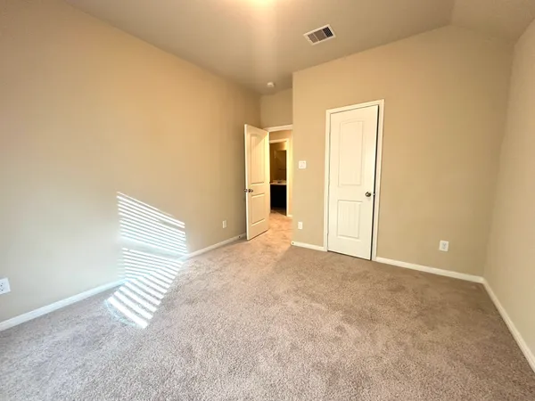a view of a living room with kitchen appliances and a window