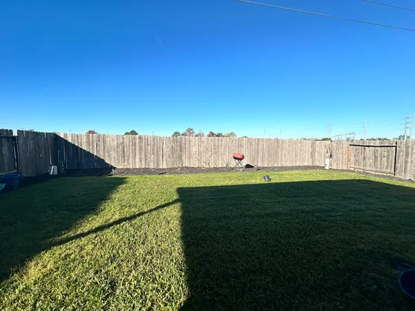 a view of a house with backyard and sitting area