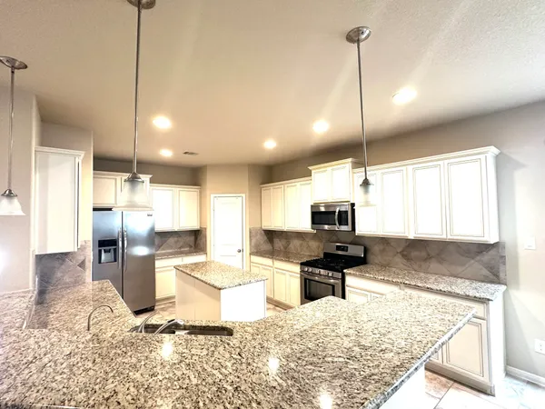 a kitchen with a refrigerator and a sink