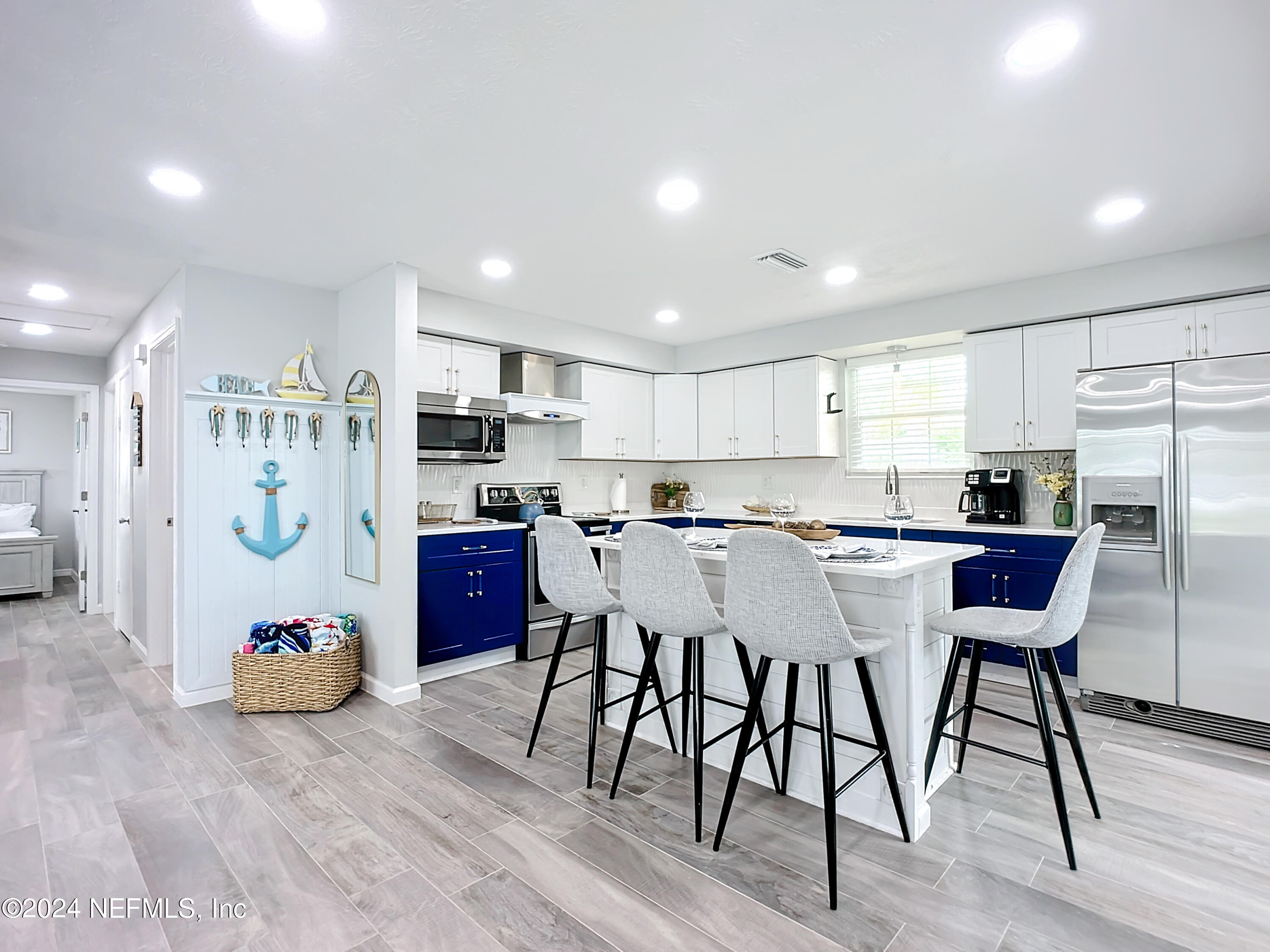 54 Surf Drive St. Augustine, FL 32080 - Photo 17 of 47 a kitchen with a table chairs refrigerator and microwave
