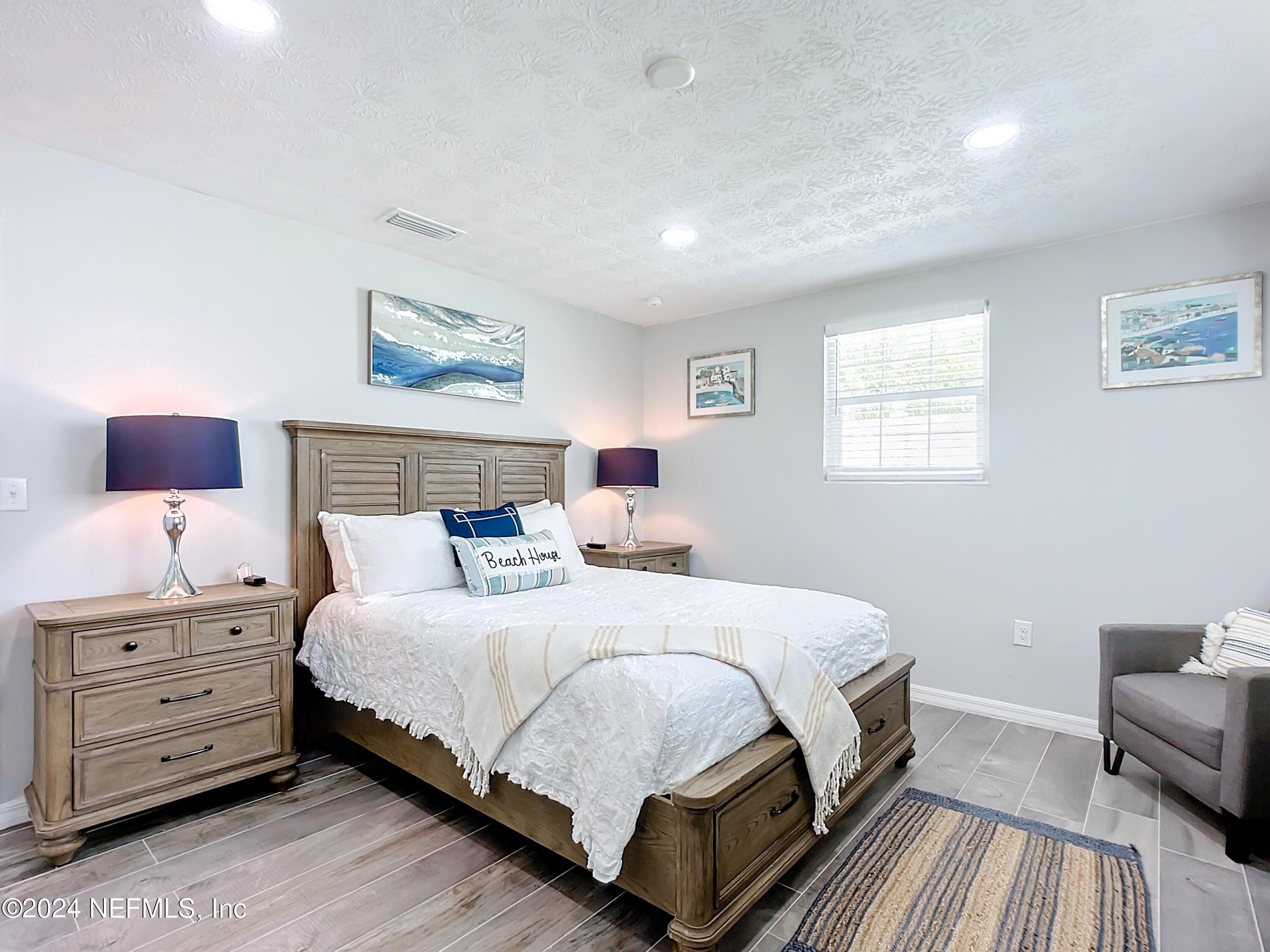54 Surf Drive St. Augustine, FL 32080 - Photo 27 of 47 a bedroom with a bed and a night stand